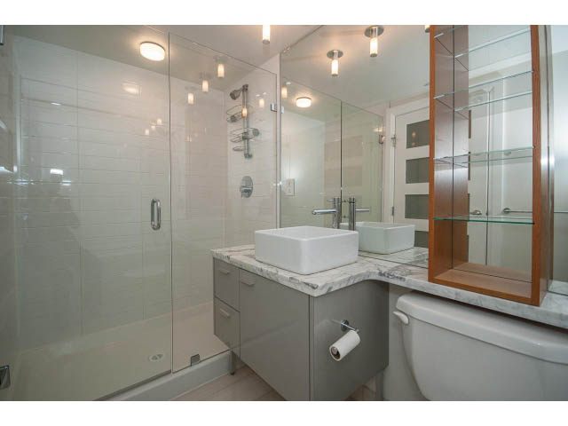 Furnished bathroom with marble countertops and modern glass shower. - 21 Smithe Mews, Vancouver Downtown