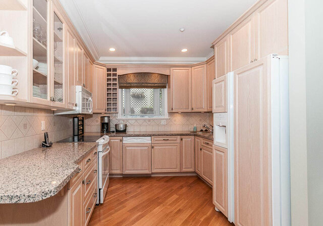 Bright kitchen with granite countertops, hardwood floors, and a window with a view. - 2031 Creelman Ave, Vancouver West Side
