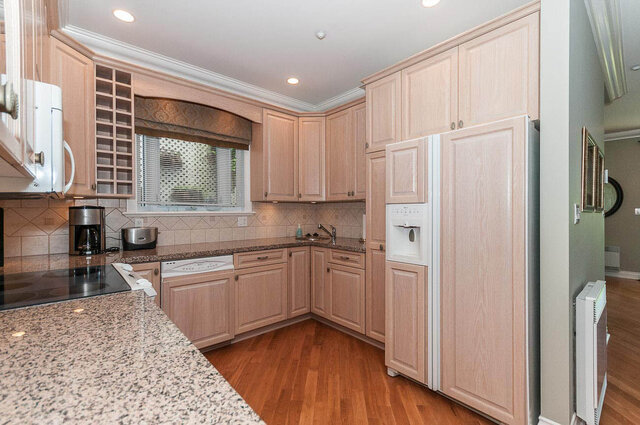 Bright kitchen with granite countertops, hardwood floors, and a large window. - 2031 Creelman Ave, Vancouver West Side