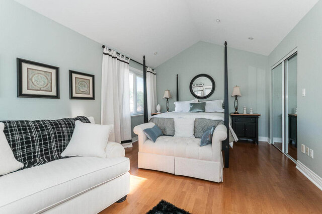 Spacious living room with hardwood floors, white furniture, and a cozy corner sofa. - 2031 Creelman Ave, Vancouver West Side