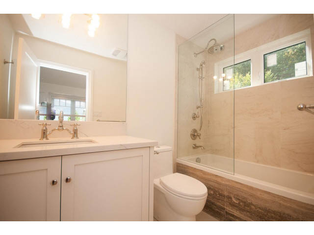 Bright bathroom with marble countertops and a large shower. - 6448 Argyle Ave, West Vancouver