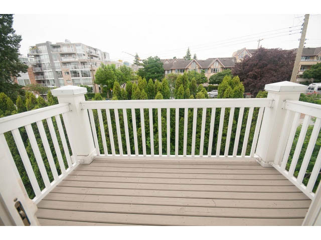 Furnished balcony with white railing and city view. - 408-1858 West 5th Avenue, Vancouver West Side