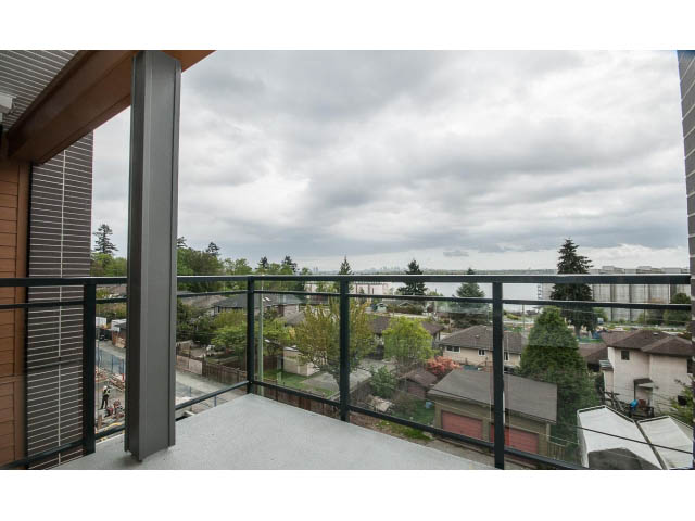 Furnished balcony with city view and glass railing. - 303 - 615 East 3rd Street, North Vancouver