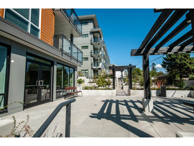 Furnished patio with modern furniture and city view. - 303 - 615 East 3rd Street, North Vancouver