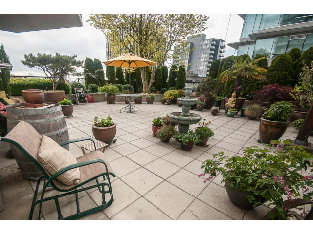 Furnished rooftop patio with potted plants, outdoor furniture, and cityscape view. - 310 - 160 E 13th St, North Vancouver