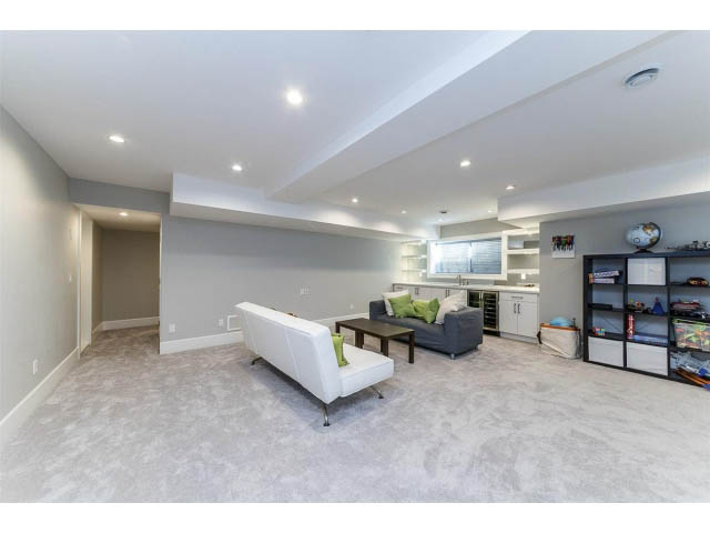 Spacious living room with white cabinets and gray walls, modern decor. - 3075 Dryden Way, North Vancouver
