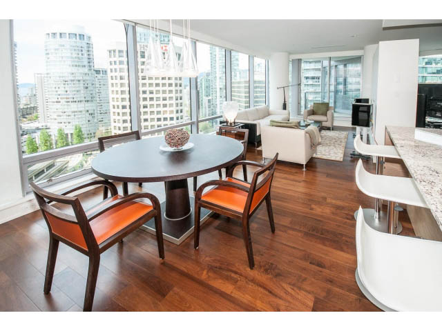 Furnished dining area with hardwood floors, city view, and modern decor. - 1902 - 1111 Alberni Street, Vancouver Downtown