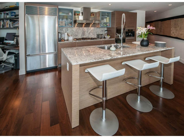 Bright kitchen with granite countertops, hardwood floors, and modern bar stools. - 1902 - 1111 Alberni Street, Vancouver Downtown
