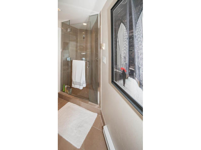 Bright bathroom with walk-in shower and cityscape artwork. - 1902 - 1111 Alberni Street, Vancouver Downtown