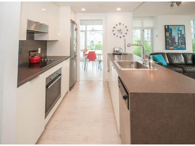 Bright kitchen with modern appliances, hardwood floors, and city view. - 501 - 161 West Georgia St, Vancouver Downtown