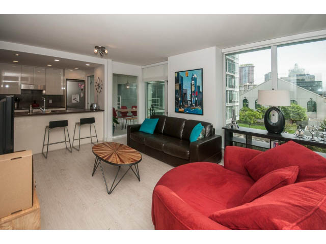 Bright living room with red couch, city view, and modern decor. - 501 - 161 West Georgia St, Vancouver Downtown