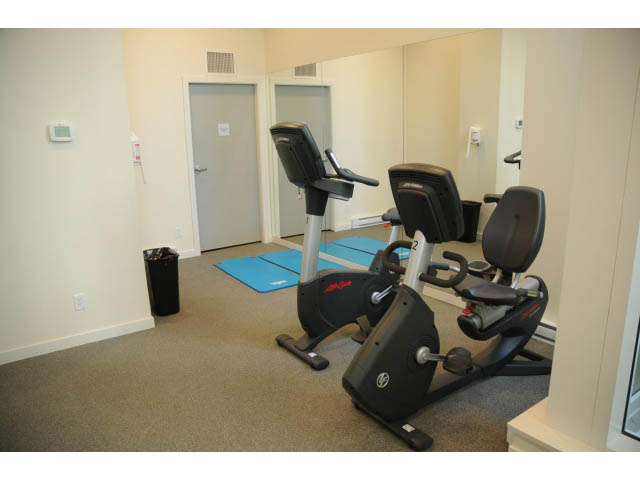 Bright fitness room with cardio equipment and mirrors. - 501 - 161 West Georgia St, Vancouver Downtown