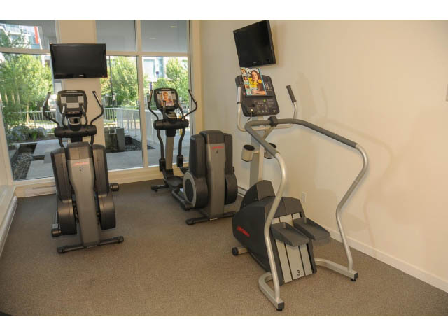Bright gym with cardio machines and city view. - 501 - 161 West Georgia St, Vancouver Downtown