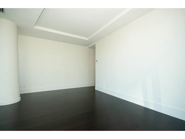 Bright living room with dark hardwood floors and white walls. - 1502- 1560 Homer Mews, Vancouver Downtown