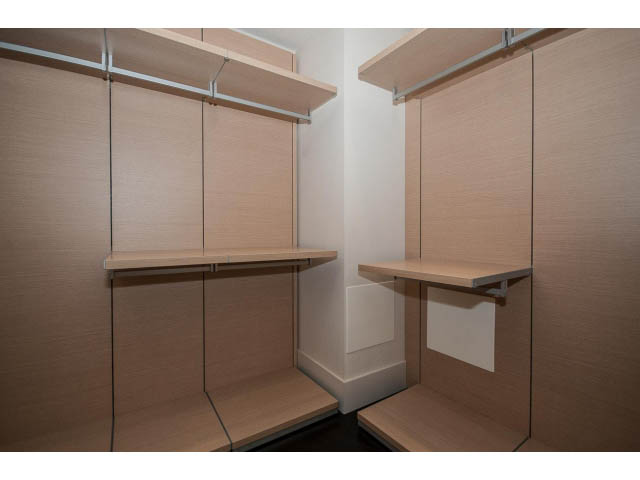 Furnished walk-in closet with wooden shelves and sliding doors. - 1502- 1560 Homer Mews, Vancouver Downtown