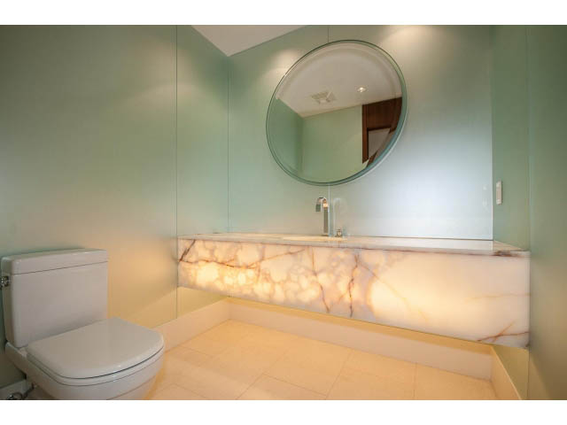 Bright bathroom with marble countertops and a round mirror. - 1502- 1560 Homer Mews, Vancouver Downtown