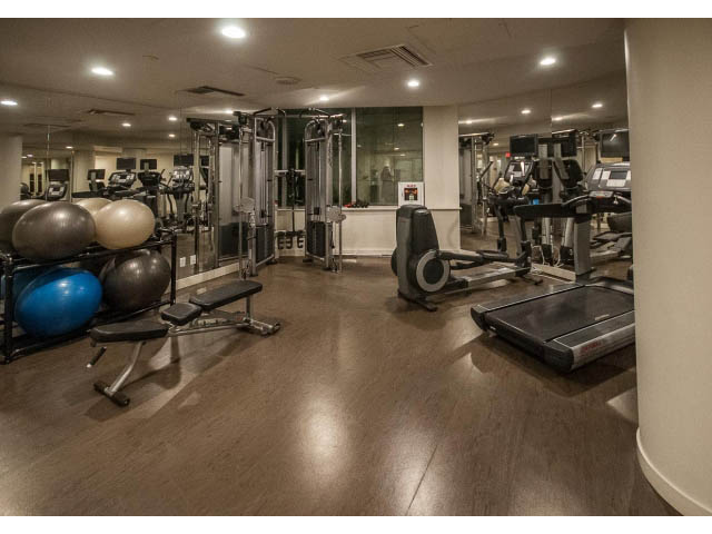 Spacious gym with cardio equipment and free weights, hardwood floors, and large mirrors. - 1502- 1560 Homer Mews, Vancouver Downtown