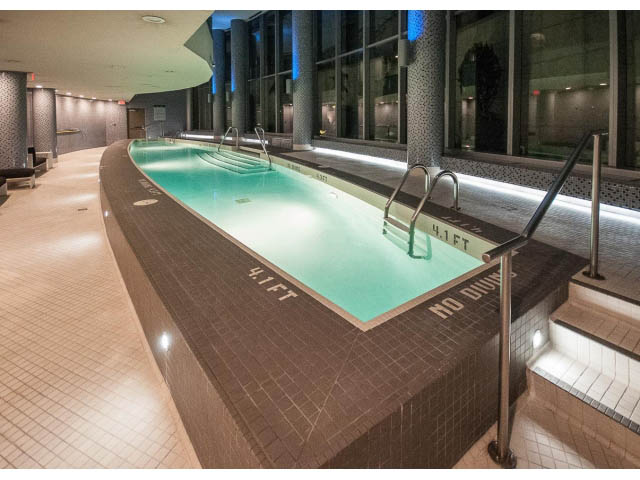 Spacious, modern indoor pool with sleek tile design and ambient lighting. - 1502- 1560 Homer Mews, Vancouver Downtown