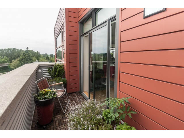 Furnished loft with red siding and outdoor plants. - 4123 - 2250 Commercial Dr, Vancouver East Side