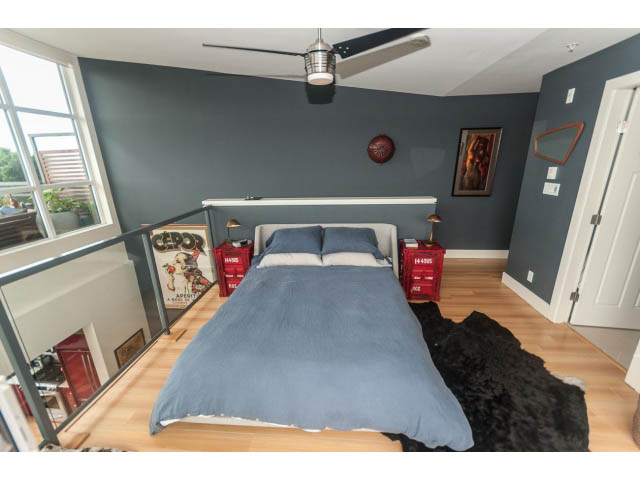 Furnished loft with hardwood floors and a cozy corner bed setup. - 4123 - 2250 Commercial Dr, Vancouver East Side