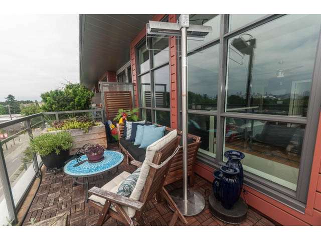 Furnished balcony with outdoor furniture, city view, and patio heater. - 4123 - 2250 Commercial Dr, Vancouver East Side