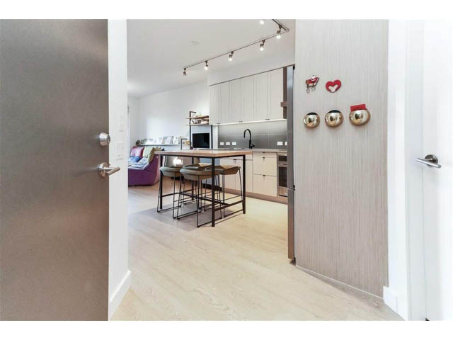 Bright kitchen with light wood countertops and hardwood floors, modern decor. - 305 - 3205 Mountain Highway, North Vancouver