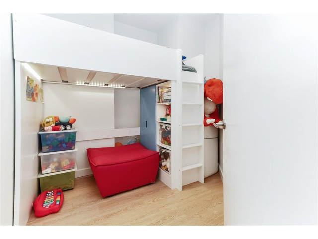 Bright, modern 1-bedroom + den with white walls, wooden floors, and a cozy bunk bed setup. - 305 - 3205 Mountain Highway, North Vancouver