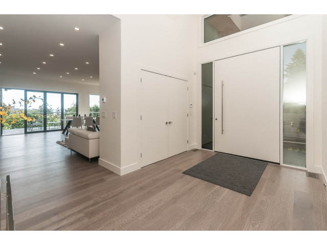 Open-concept living area with hardwood floors and sliding glass doors leading to a balcony. - 460 Hillcrest Street, West Vancouver