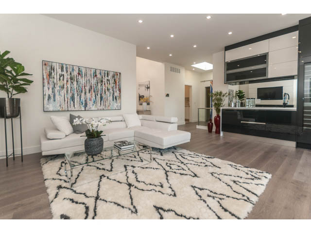 Spacious living room with modern decor, hardwood floors, and a large abstract painting. - 460 Hillcrest Street, West Vancouver