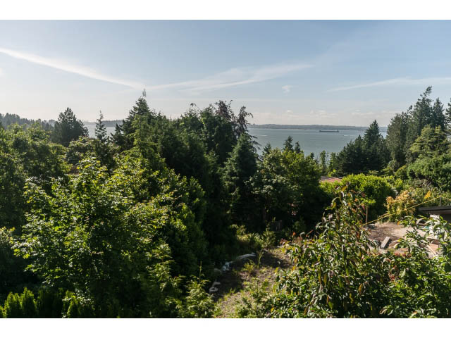 Furnished living room with a stunning view of the water and lush greenery. - 460 Hillcrest Street, West Vancouver