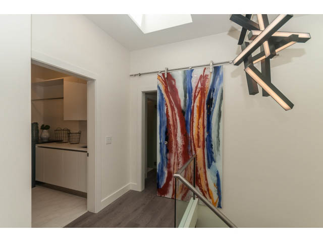 Bright kitchen with modern lighting and colorful abstract artwork on sliding doors. - 460 Hillcrest Street, West Vancouver