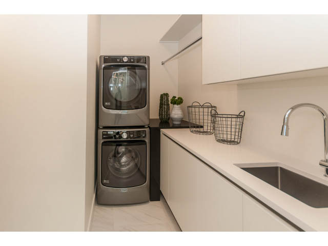 Bright laundry room with modern appliances and white countertops. - 460 Hillcrest Street, West Vancouver