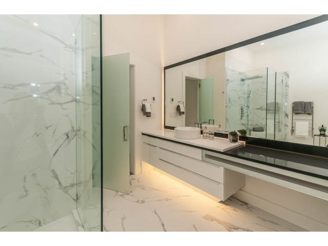 Modern bathroom with marble countertops and glass shower enclosure. - 460 Hillcrest Street, West Vancouver