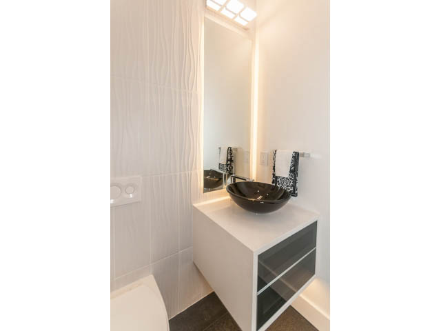 Modern bathroom with sleek white vanity and black accents. - 460 Hillcrest Street, West Vancouver