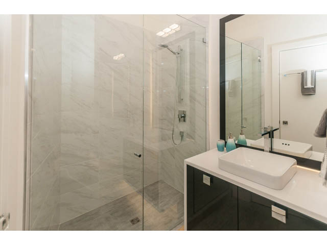 Modern bathroom with marble countertops and glass shower. - 460 Hillcrest Street, West Vancouver