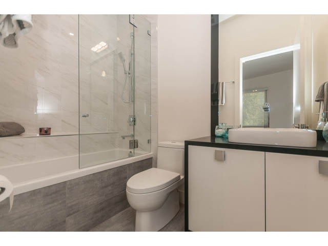 Modern bathroom with marble countertops and a glass shower. - 460 Hillcrest Street, West Vancouver