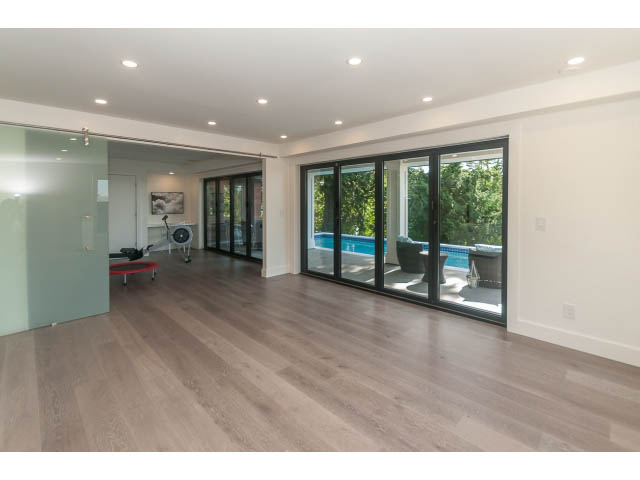 Spacious living room with hardwood floors and large windows. - 460 Hillcrest Street, West Vancouver