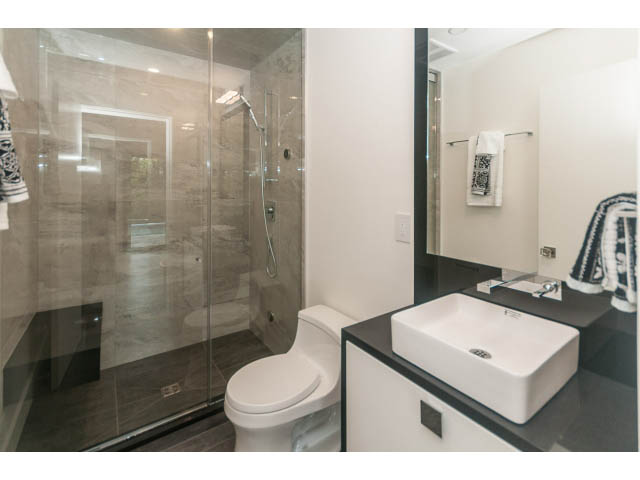 Modern bathroom with glass shower and white sink. - 460 Hillcrest Street, West Vancouver