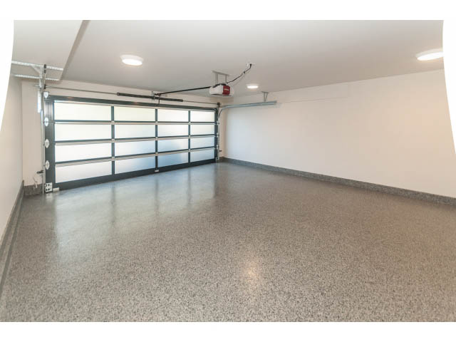 Spacious garage with polished concrete floor and overhead garage door. - 460 Hillcrest Street, West Vancouver