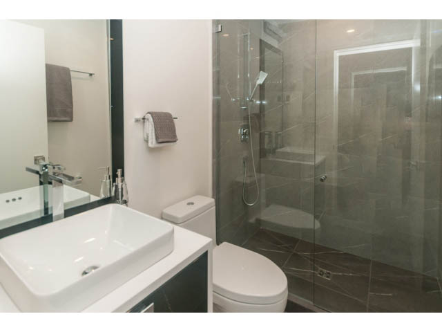 Modern bathroom with a large sink, glass shower, and toilet. - 460 Hillcrest Street, West Vancouver