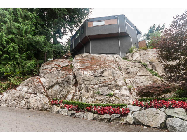 Modern house with a unique rock-climbing wall and vibrant flower garden. - 5385 Kew Cliff Rd, West Vancouver