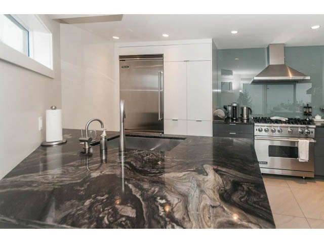 Bright kitchen with modern stainless steel appliances and granite countertops. - 5385 Kew Cliff Rd, West Vancouver