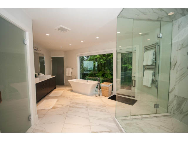Spacious bathroom with marble countertops and glass shower. - 5385 Kew Cliff Rd, West Vancouver