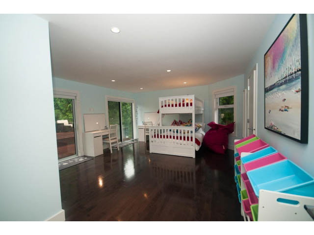 Bright 5-bedroom house with hardwood floors and large windows, showcasing a serene outdoor view. - 5385 Kew Cliff Rd, West Vancouver
