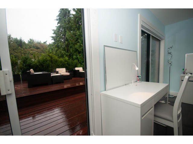 Bright living room with large windows, hardwood deck, and city view. - 5385 Kew Cliff Rd, West Vancouver