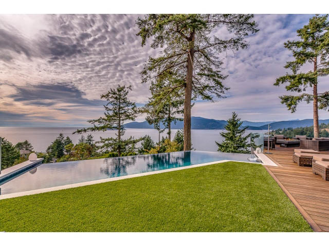 Spacious living room with a stunning ocean view and infinity pool. - 5385 Kew Cliff Rd, West Vancouver