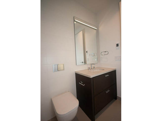 Bright bathroom with modern vanity, sleek mirror, and dark wood cabinets. - Suite # Withheld - 2958  Burfield Place, West Vancouver
