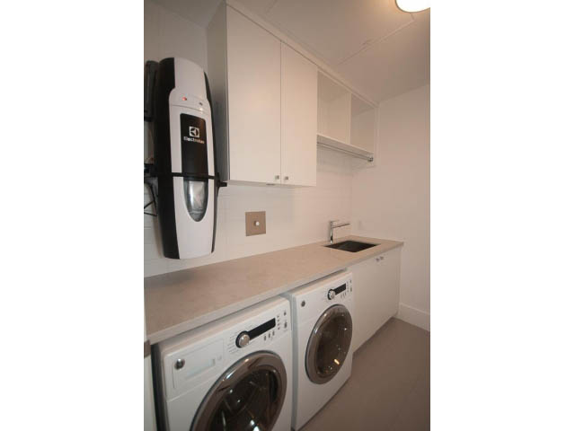 Bright laundry room with white cabinets, countertop, and modern appliances. - Suite # Withheld - 2958  Burfield Place, West Vancouver