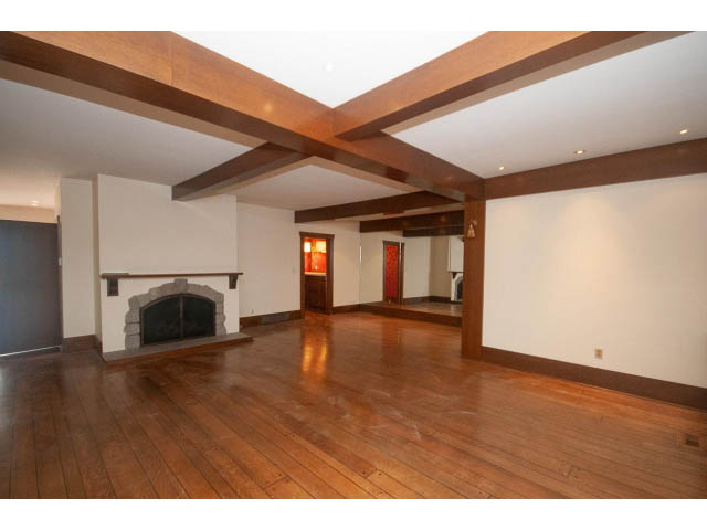 Bright living room with hardwood floors and exposed wooden beams. - 2047 West 35th Avenue, Vancouver West Side