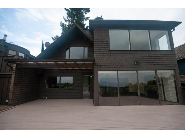 Spacious deck with modern glass doors leading to a cozy interior. - 2047 West 35th Avenue, Vancouver West Side